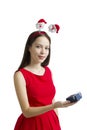 Young woman hands a present wrapped in red paper with white bow, isolated on Royalty Free Stock Photo