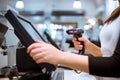 Young woman hands scaning, entering discount, sale on a receipt, touchscreen cash register, POS, finance concept Royalty Free Stock Photo