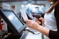 Young woman hands scaning, entering discount, sale on a receipt, touchscreen cash register, POS, finance concept Royalty Free Stock Photo