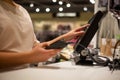 Young woman hands scaning, entering discount, sale on a receipt, touchscreen cash register, shop, finance concept