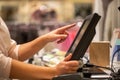 Young woman hands scaning, entering discount, sale on a receipt, touchscreen cash register, shop, finance concept