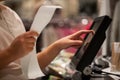 Young woman hands scaning, entering discount, sale on a receipt, touchscreen cash register, shop, finance concept