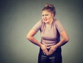 Young woman hands on stomach having bad aches pain. Food poisoning, influenza, cramps. Royalty Free Stock Photo