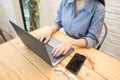 Young woman hands typing laptop computer in cafe. working woman concept Royalty Free Stock Photo