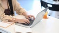 Young woman hands typing on laptop computer and sitting in coffee shop. Royalty Free Stock Photo