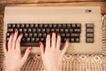 Woman working on old computer keyboard Royalty Free Stock Photo