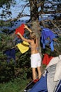 Young woman hanging out washing on a tree