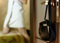 Young woman hangs a bra on the door handle. girl in stockings and towel in hotel room Royalty Free Stock Photo