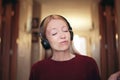 Young Woman Happily Jamming to Music on Her Bluetooth Headphones Royalty Free Stock Photo