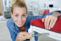 Young woman happily sanding chair Royalty Free Stock Photo