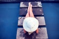 Young woman happy in big hat relaxing on the swimming pool, travel near the sea and beach. Concept summer Royalty Free Stock Photo