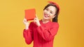 Young woman happy smile hold gift box in hands, isolated over yellow background Royalty Free Stock Photo