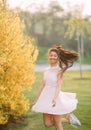 Young woman has enjoy and relaxes near blooming forsythia bushes