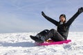 A young woman has fun sledging in winter
