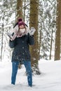 A young woman has fun in a winterly forest
