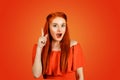 Young woman has an idea, pointing with finger up Royalty Free Stock Photo