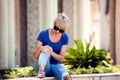 Young woman has knee pain during outdoor walking. Healthcare, medicine, people concept Royalty Free Stock Photo