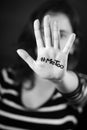 Young woman with the hashtag MeToo written on her hand