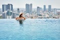 Young woman enjoy summer vacation in roof top swimming pool Royalty Free Stock Photo