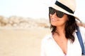 Young woman with hat enjoying the beach while on holiday