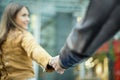 Young woman hat holding man by hand in city urban center - Boyfriend following beloved girlfriend during holidays honeymoon - Love Royalty Free Stock Photo