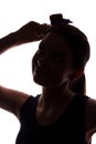 Young woman in hat looking up - vertical silhouette