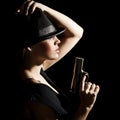 The young woman in a hat and with a pistol