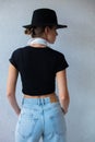 Young woman in hat and 90s style clothes