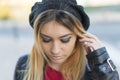 Young woman a hat on the street.