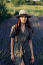 Young woman in hat walks among lavender field Royalty Free Stock Photo