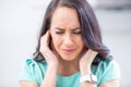 Young woman have headache migraine stress or tinnitus - noise whistling in her ears