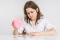 Young woman have no money. Her piggy money bank with savings is empty Royalty Free Stock Photo