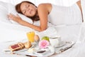 Young woman having breakfast in bed Royalty Free Stock Photo