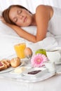 Young woman having breakfast in bed Royalty Free Stock Photo