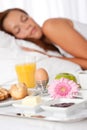 Young woman having breakfast in bed Royalty Free Stock Photo