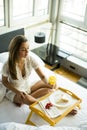 Young woman having breakfast in bed Royalty Free Stock Photo