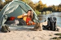 Young woman having breakfast in sleeping bag inside Royalty Free Stock Photo