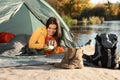 Young woman having breakfast in sleeping bag Royalty Free Stock Photo