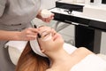 Woman having cosmetic facial seaweed treatment in spa