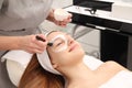 Woman having cosmetic facial seaweed treatment in spa