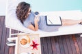 Young woman having cup of tea near poolside Royalty Free Stock Photo