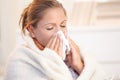 Young woman having flu blowing her nose Royalty Free Stock Photo