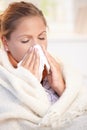 Young woman having flu blowing her nose Royalty Free Stock Photo