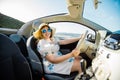 Young woman drive and having fun in cabrio against beach and sea - travel and summer voyage nature concept