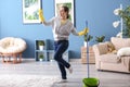 Young woman having fun while cleaning her flat Royalty Free Stock Photo