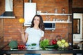 Young woman having fun in kitchen, juggle with vegetables at home