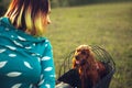 Young woman having fun near countryside park, riding bike, traveling with companion spaniel dog Royalty Free Stock Photo