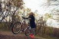 Young woman having fun near countryside park, riding bike, traveling at spring day Royalty Free Stock Photo