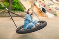 Woman having fun on a seesaw swing at urban playground