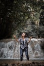 Young woman having fun under waterfalls Royalty Free Stock Photo